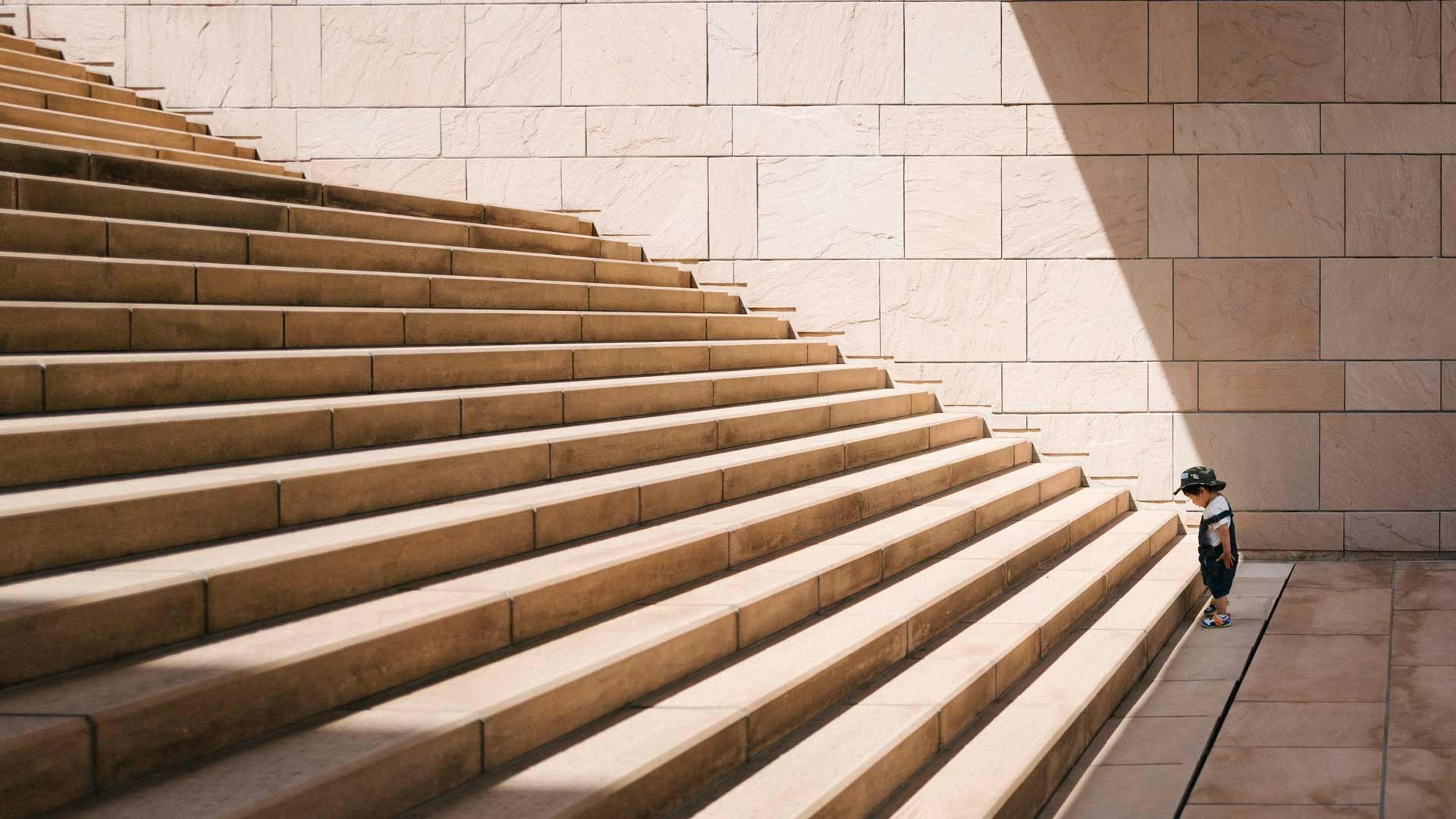 Kid Looking Up at Stairs